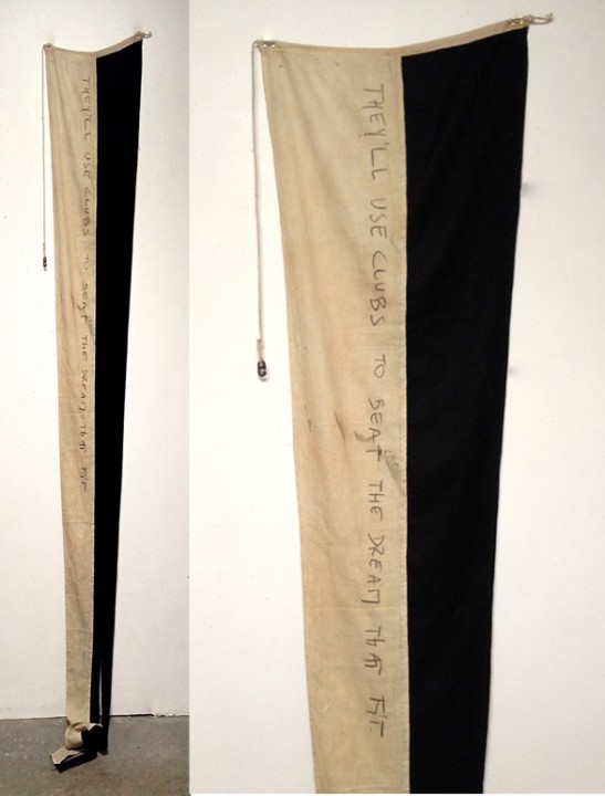 Andy Wauman, THEY'LL USE CLUBS TO BEAT THE DREAM THAT FIT, 2014, ink on vintage flag, 19 x 106 inches.