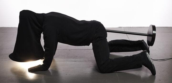 Mike Simi, Lamp, 2016, mixed media with street clothing, electronics, 24 x 24 x 60 inches.